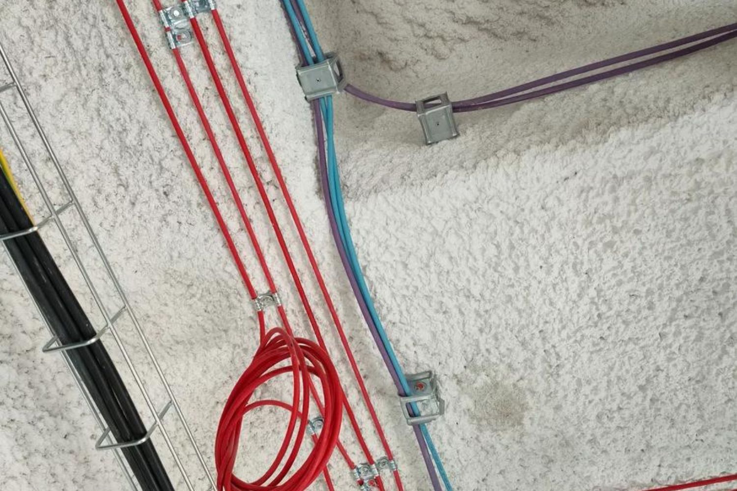 Imagen de cables colgados del techo mediante el soporte metálico para agrupación de cables CHS